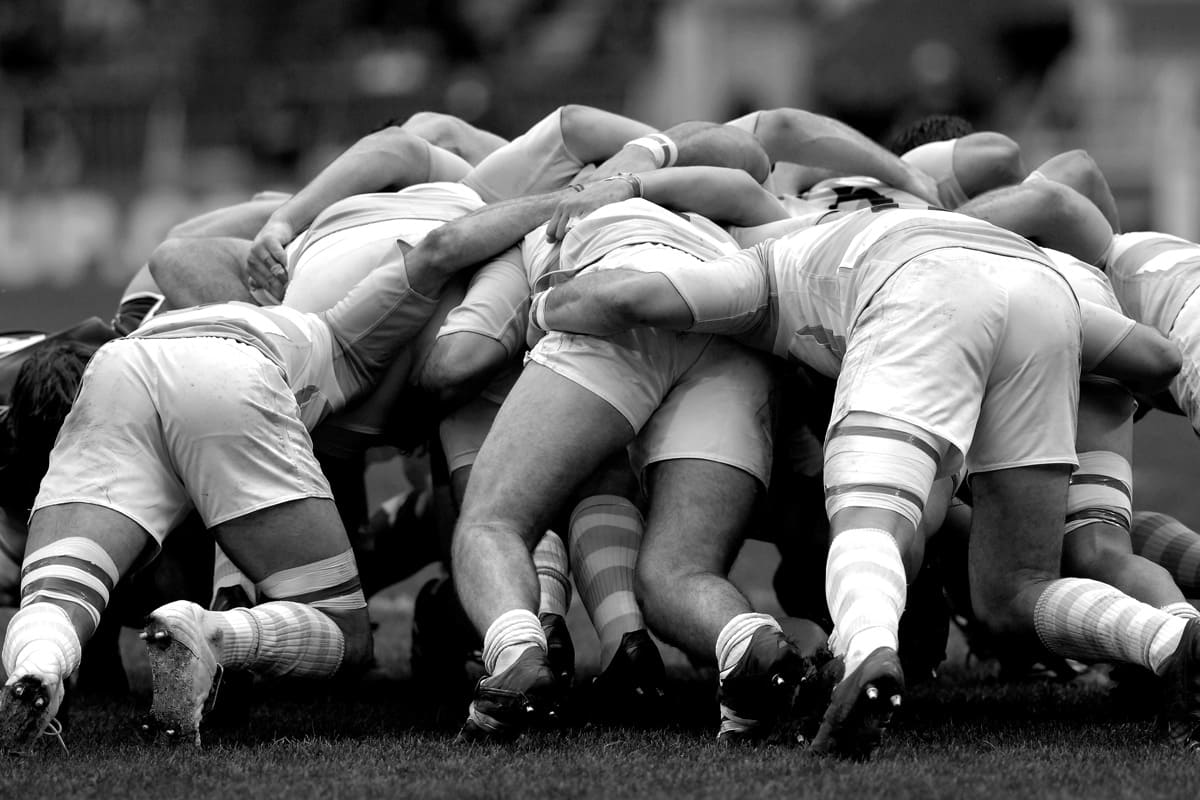 Agile Leadership: Rugby Mannschaft über dem Ball